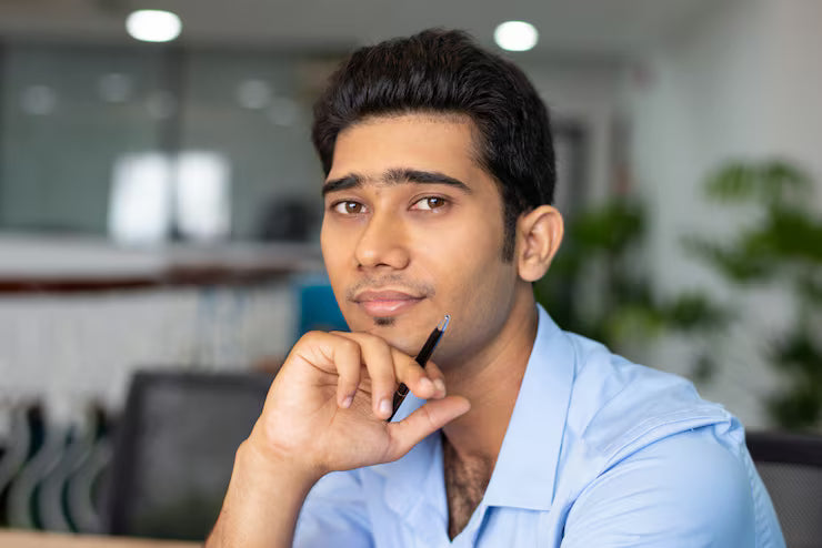 files/portrait-young-indian-businessman-student-sitting-with-pen_1262-17490.avif